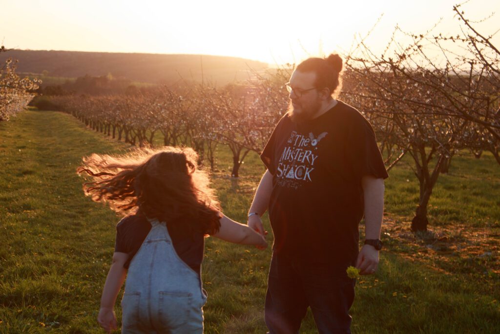 Petite fille et son père partageant un moment complice à la golden hour à Jussy près d’Auxerre
